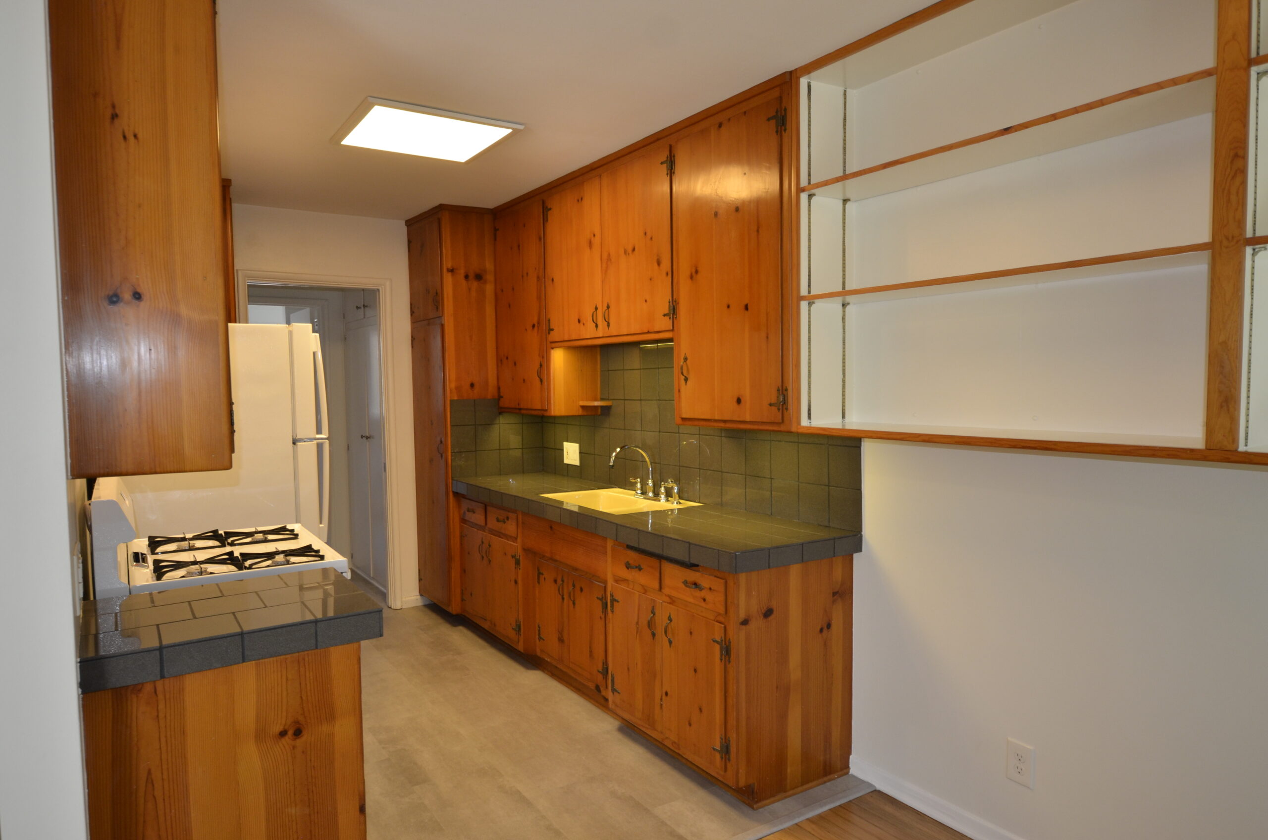 Apt 3 Galley kitchen with hall to bedroom bathroom and extra closet