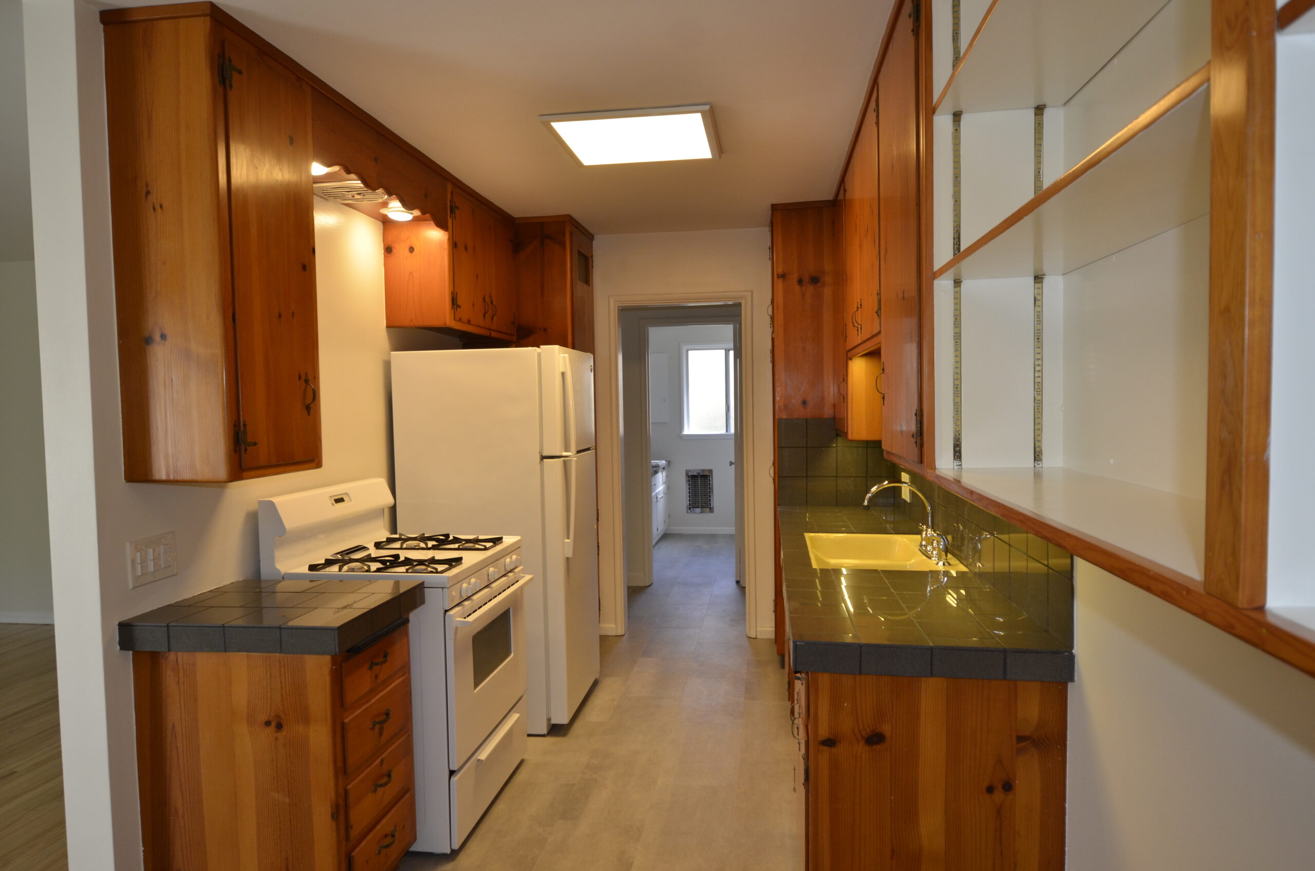 Apt 3 Galley kitchen with hall to bedroom bathroom and extra closet