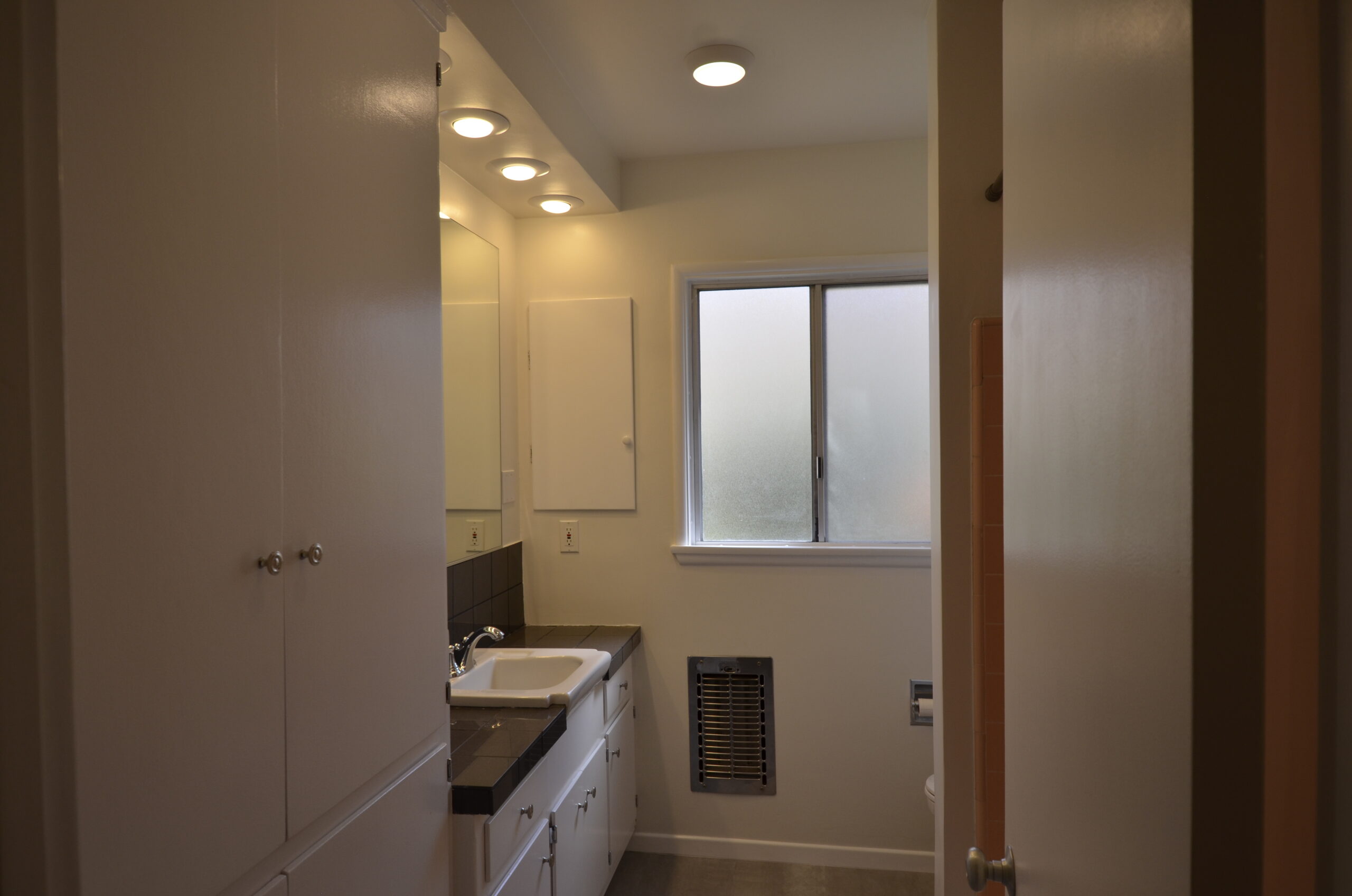 Apt 3 bathroom with linen cupboard and tub/shower