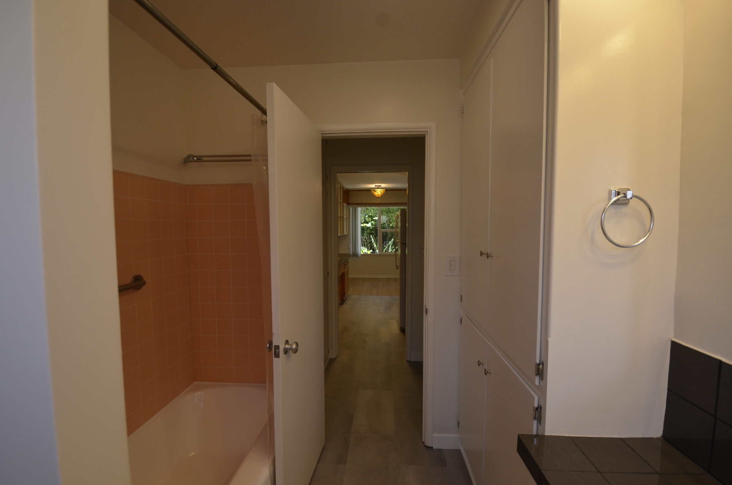 Apt 3 bathroom with linen cupboard and tub/shower
