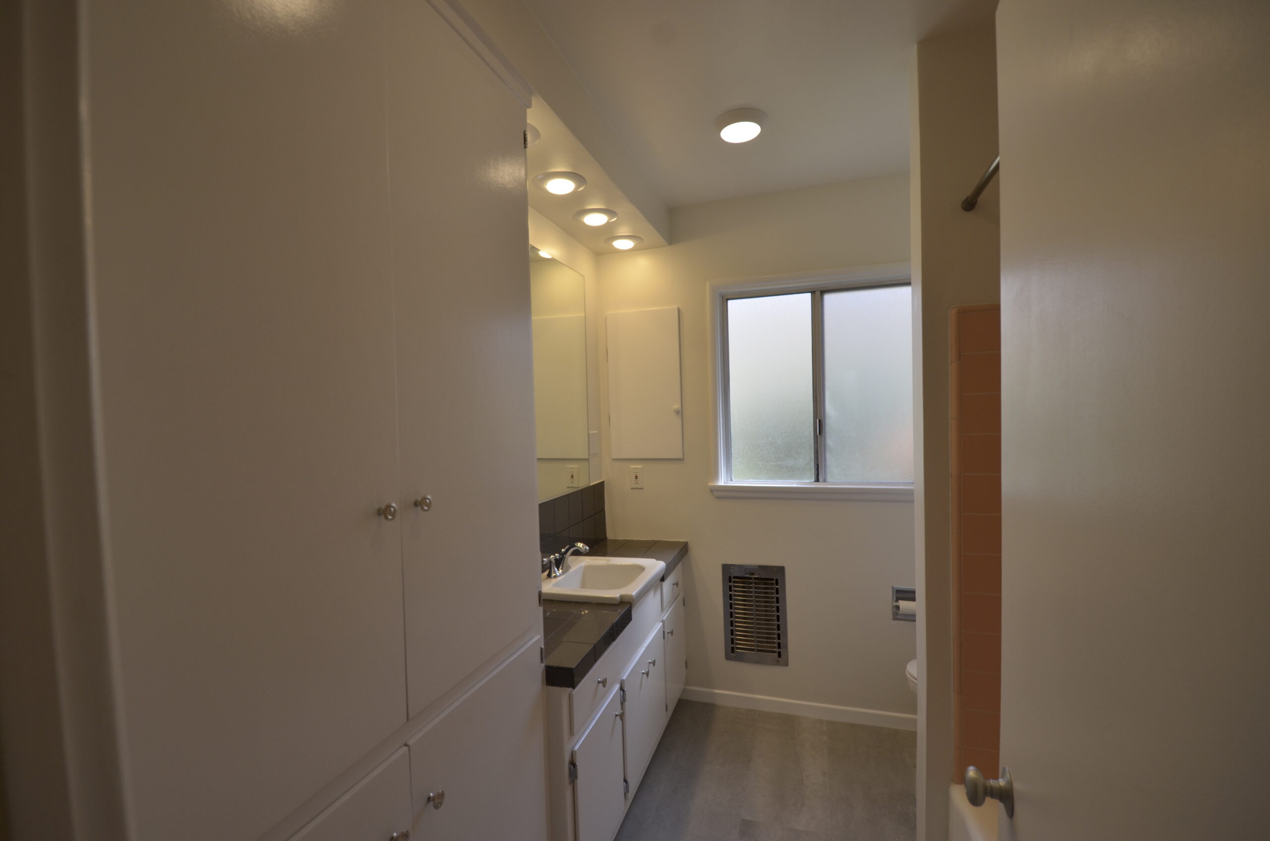 Apt 3 bathroom with linen cupboard and tub/shower